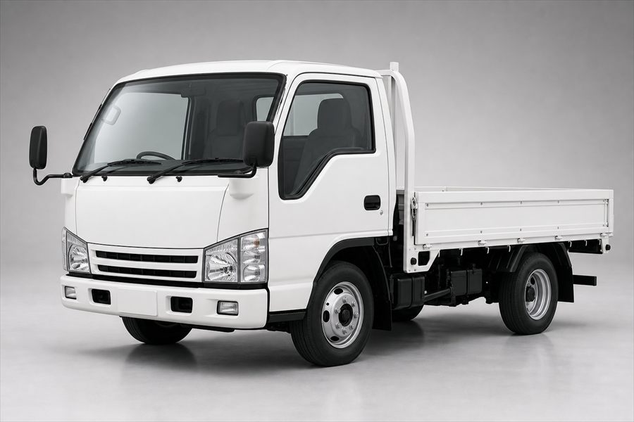 White Japanese light commercial flatbed truck photographed in a studio